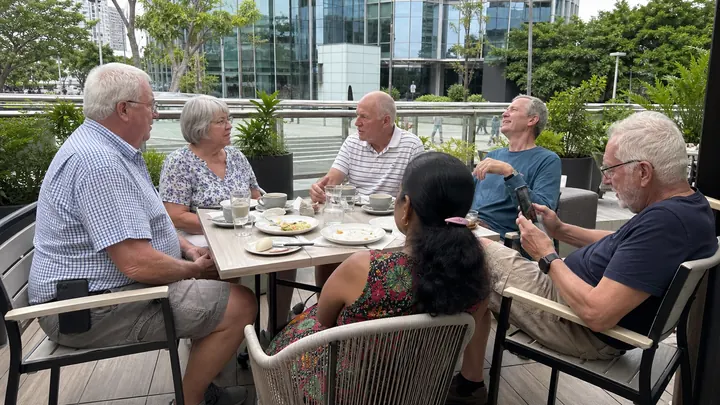 Retirees having breakfast together at an outdoor café