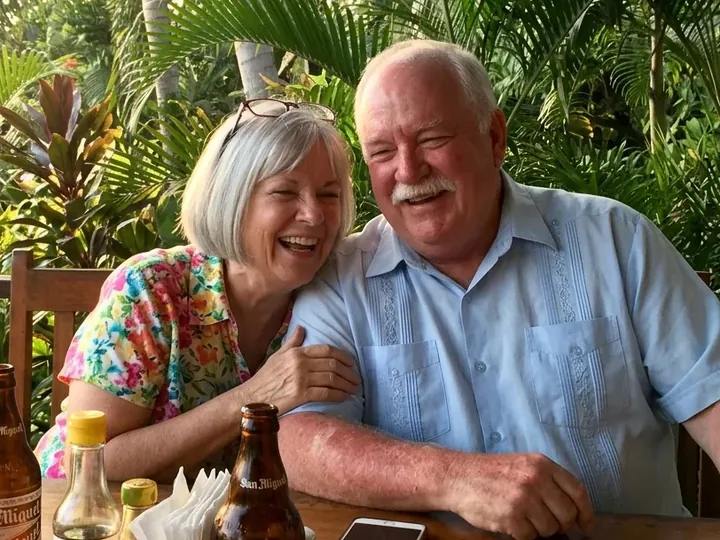 Linda and Robert P. laughing together at a café table in Cebu