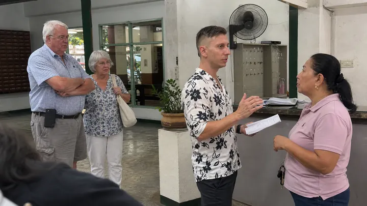 Valery talking terms with an apartment owner in a lobby