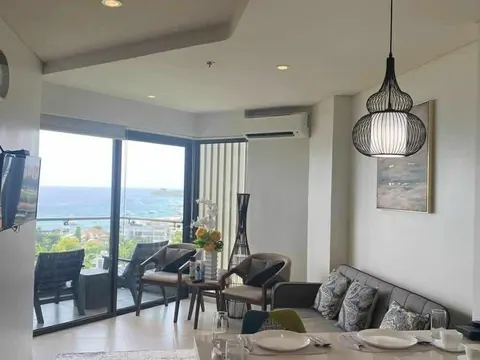 A new living and dining room with a wide window over the sea